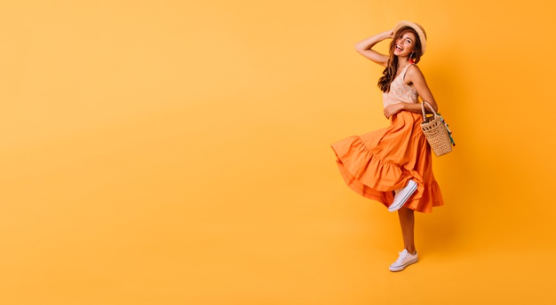 magnificent-woman-long-bright-skirt-dancing-studio-carefree-inspired-female-model-posing-with-pleasure-yellow_197531-11084